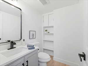 Half bath featuring vanity and light wood-type flooring