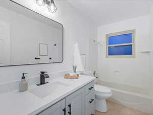 Full bathroom with vanity,  shower combination, and light tile patterned floors