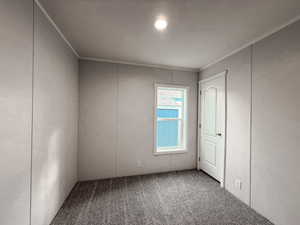 Unfurnished bedroom featuring carpet and crown molding