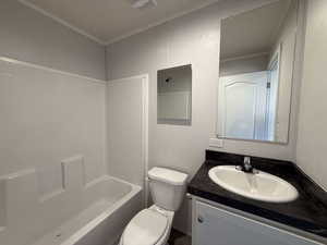 Bathroom featuring vanity, shower / tub combination, and crown molding