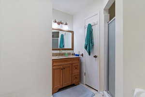 Bathroom with a stall shower and vanity