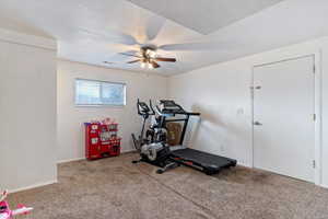 Workout area featuring carpet, ceiling fan, and a textured ceiling