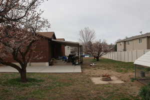 View of yard with a patio and an outdoor fire pit