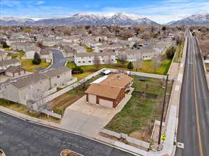 Aerial overview of property's location featuring a mountainous background and nearby suburban area