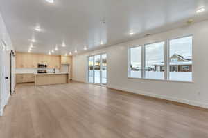 Unfurnished living room with light wood-style flooring and recessed lighting