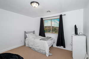 Carpeted bedroom featuring baseboards