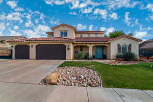 Mediterranean / spanish-style home featuring stucco siding, driveway, an attached garage, a front yard, and a tile roof