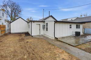 Back of property featuring board and batten siding and a patio