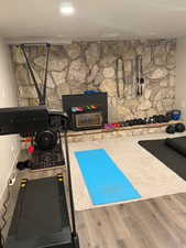 Workout area with wood finished floors