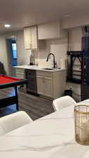 Kitchen featuring beverage cooler, white cabinetry, dark wood-type flooring, and recessed lighting