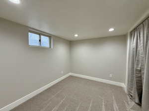 Unfurnished bedroom featuring recessed lighting and light carpet