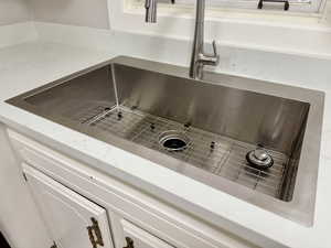Kitchen view of light stone countertops and white cabinets