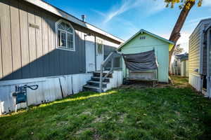 Back of property featuring a lawn