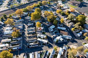 Aerial view of property and surrounding area featuring nearby suburban area
