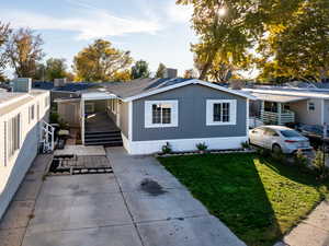 View of front of property with a front lawn and a patio