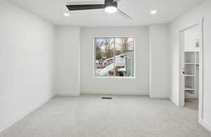 Unfurnished bedroom with light carpet, ceiling fan, and recessed lighting