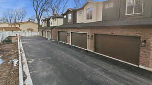 View of home's exterior with a residential view, brick siding, stucco siding, and roof with shingles