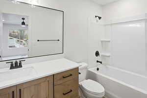 Full bathroom featuring vanity, bathtub / shower combination, and ceiling fan