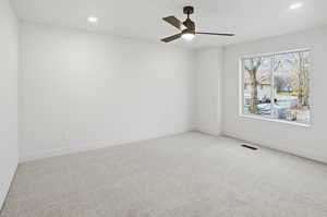 Empty room with carpet, recessed lighting, and a ceiling fan