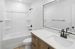 Full bathroom featuring vanity, bathing tub / shower combination, and light wood finished floors