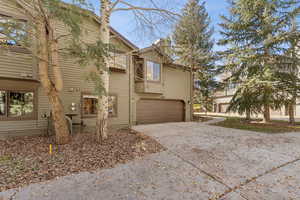 View of front facade featuring driveway and a garage