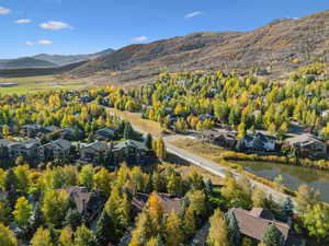 Aerial overview of property's location with nearby suburban area and mountains