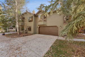 View of front of home featuring concrete driveway and an attached garage
