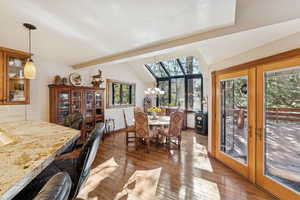 Dining space featuring light wood-style floors, french doors, and wine cooler