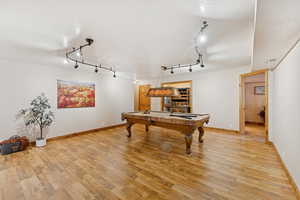 Playroom featuring a textured ceiling, light wood finished floors, billiards table, and track lighting