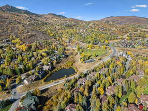 Aerial overview of property's location with nearby suburban area and a water and mountain view