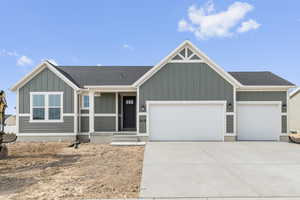 View of front of house featuring board and batten siding, roof with shingles, a garage, concrete driveway, and a porch