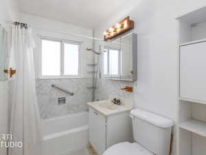 Full bath with vanity, shower / tub combo with curtain, and decorative backsplash