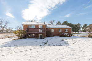 View of the back of home, featuring deck & walk-out basement