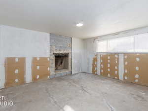 Unfinished basement featuring a fireplace