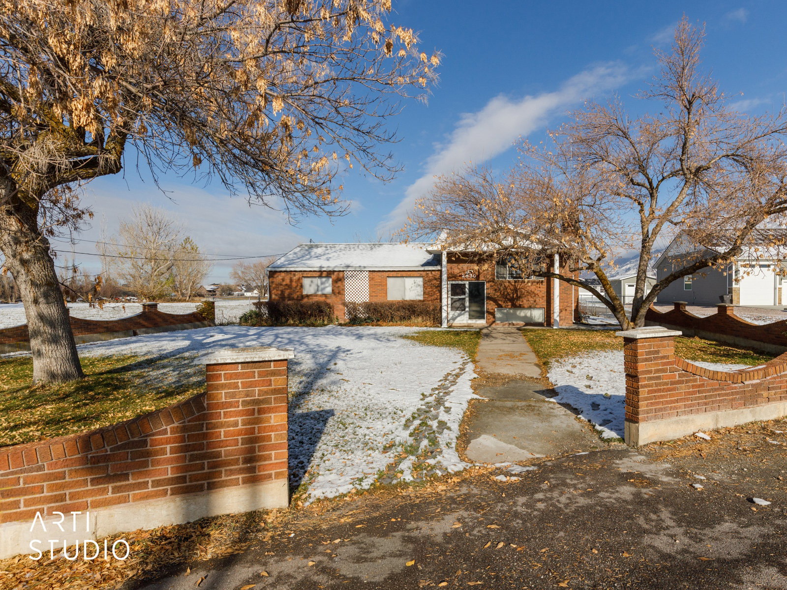 View of front of home & brick fence