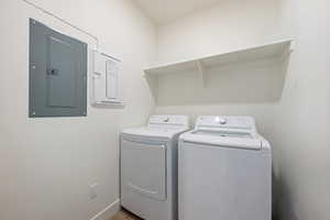 Washroom with electric panel and washing machine and dryer