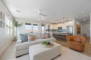Living area with light wood-type flooring, ceiling fan, and recessed lighting