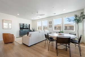 Dining space with a ceiling fan, light wood finished floors, and recessed lighting