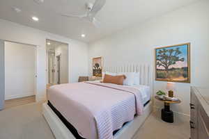 Bedroom with a ceiling fan, recessed lighting, and light carpet