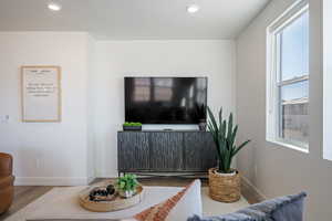 Living room with wood finished floors and recessed lighting
