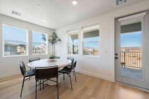 Dining area featuring light wood-type flooring and plenty of natural light