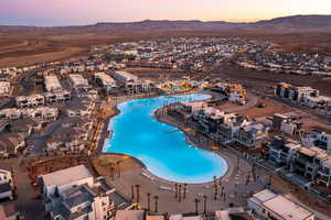 Aerial view of property's location with a mountain backdrop and a pool