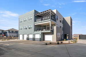 View of apartment building / complex featuring driveway and an attached garage
