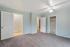 Unfurnished bedroom featuring light colored carpet and ceiling fan