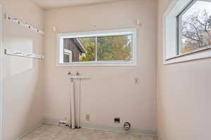 Washroom featuring baseboards and light tile patterned floors