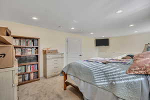 Bedroom featuring recessed lighting, light colored carpet, and a textured ceiling