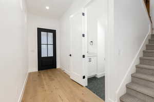 Entrance foyer with stairway, light wood-style flooring, and recessed lighting