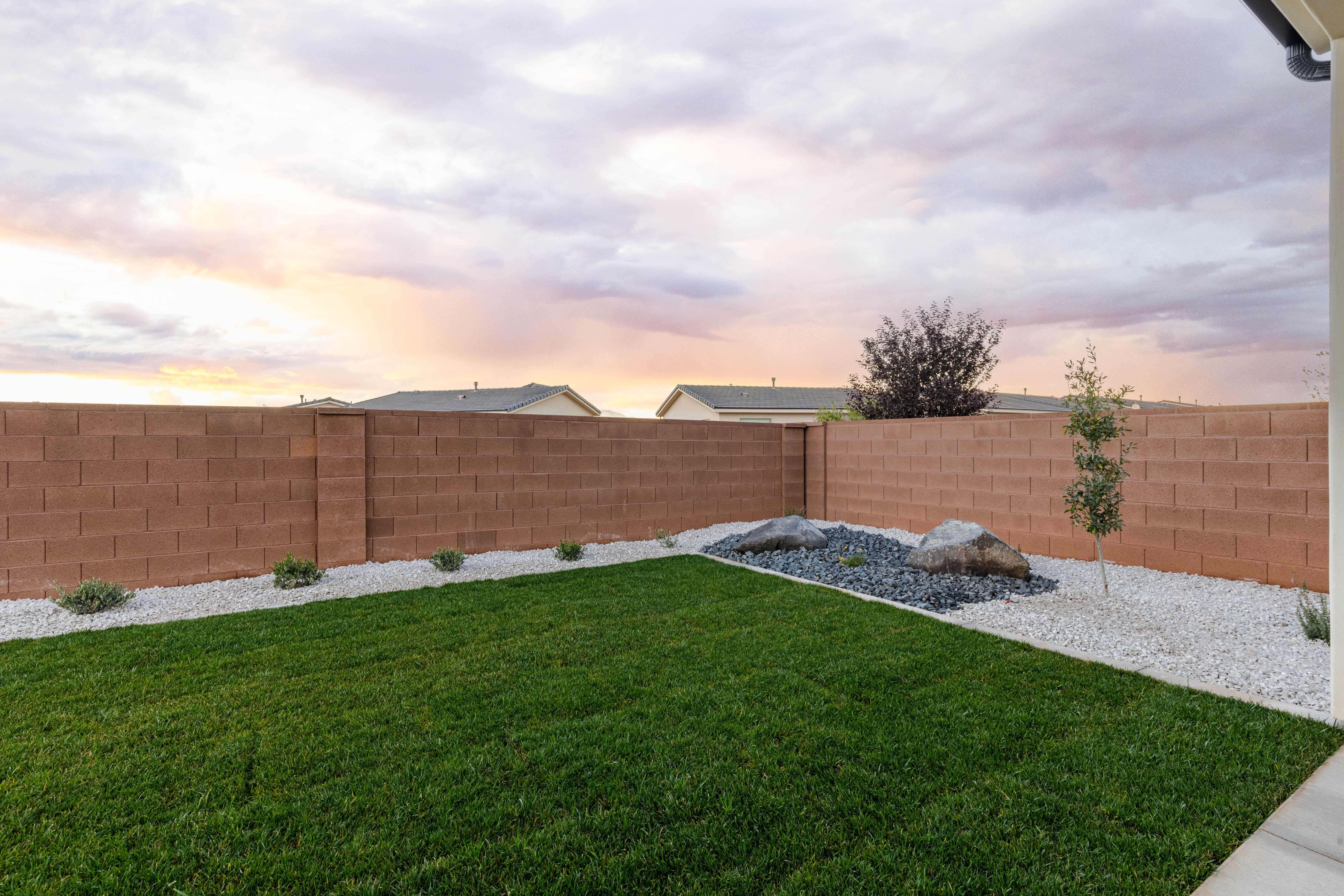 Yard at dusk featuring a fenced backyard