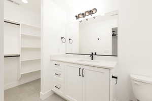 Bathroom with vanity and recessed lighting