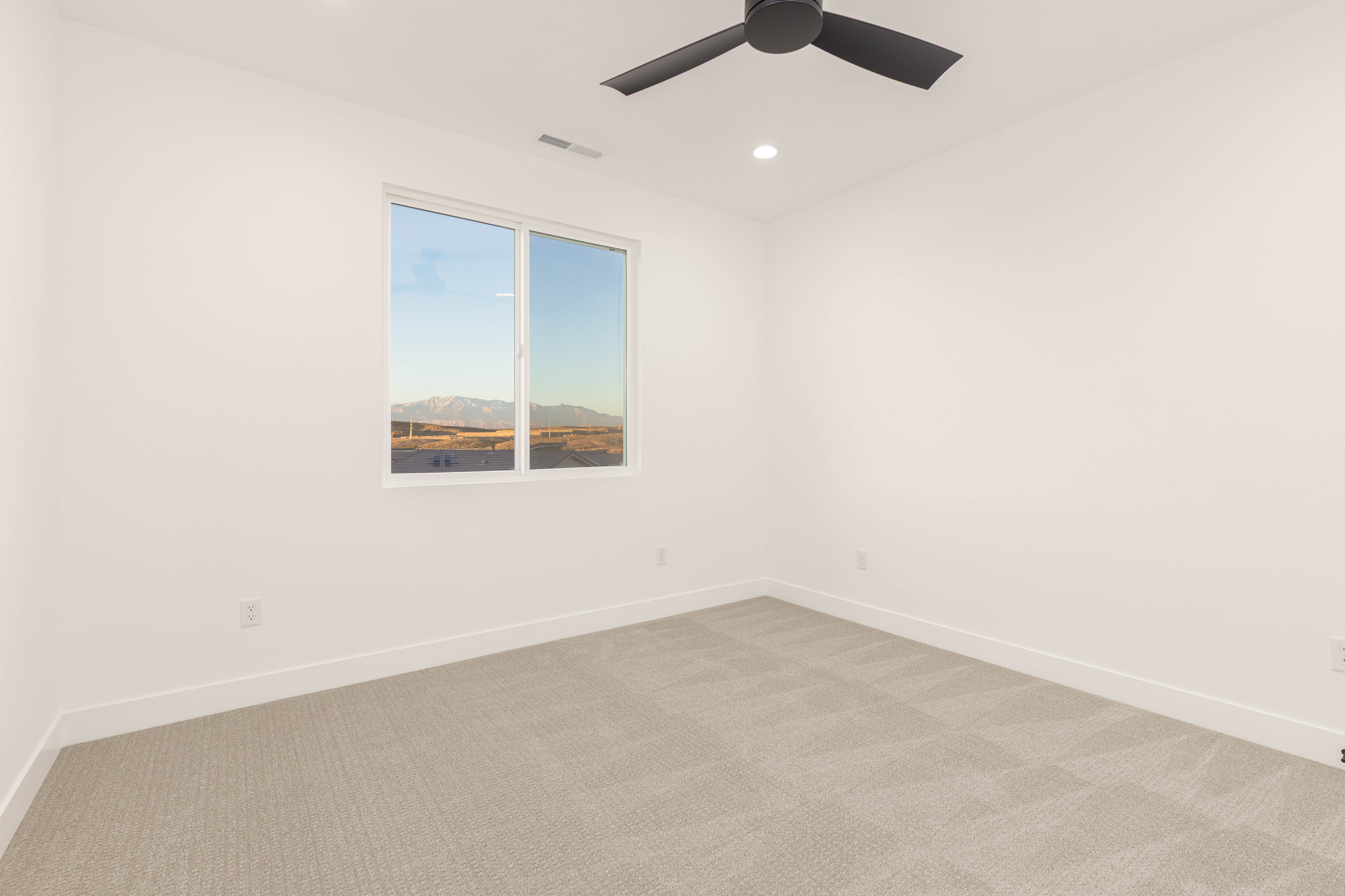 Carpeted empty room with baseboards and recessed lighting